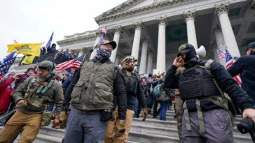 Members of the Oath Keepers extremist group stand on the East Front of the U.S. Capitol on Jan. 6, 2021, in Washington. David Moerschel, a 45-year-old neurophysiologist from Punta Gorda, Fla., who stormed the U.S. Capitol with other members of the far-right Oath Keepers group, was sentenced Friday to three years in prison for seditious conspiracy and other charges, the latest in a historic string of sentences in the Jan. 6. 2021 attack.