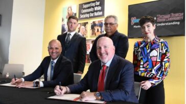 Thomas Edison State University representative Thomas Phillips (front row, from left) and Pantex Deputy Site Manager Kenny Steward sign a memorandum of understanding that offers Pantex employees deferred tuition and a reduced tuition rate for the school’s online programs. Looking on are (back row, from left) Pantex employee Justin Fox, Carlos Alvorado of the National Nuclear Safety Administration Production Office and Pantex employee Shelbi Gray.